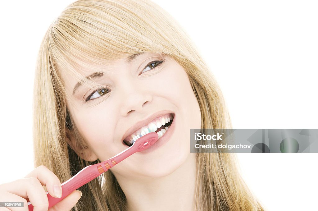 Its happier and healthier to brush your teeth 2 times a day picture of happy girl with toothbrush over white Adult Stock Photo