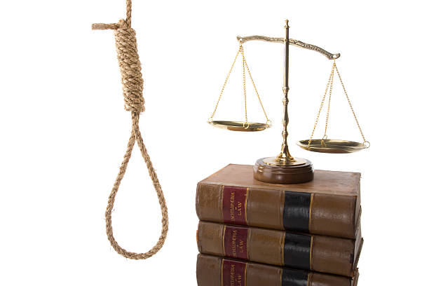 Death Penalty hangman's noose, scales, and law books stock photo