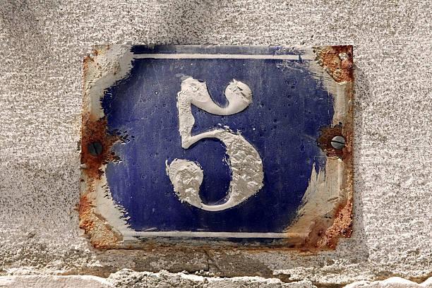 istock Old rusted number 5 house number over blue on a gray wall 92042286