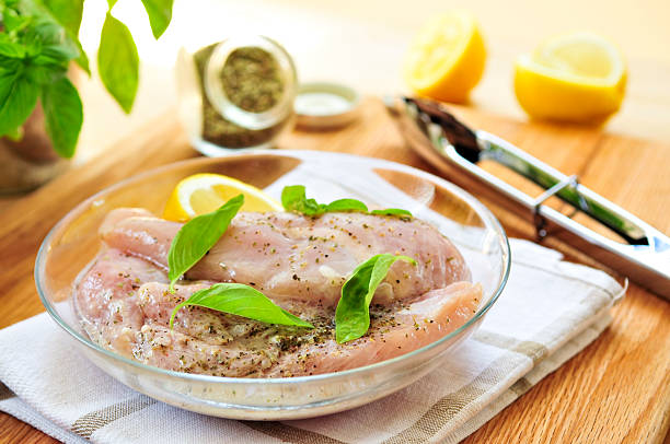 Raw chicken breasts marinating  marinated photos stock pictures, royalty-free photos & images