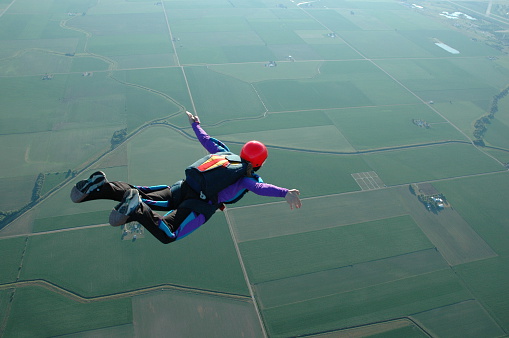 Skydiver flying over the beach.