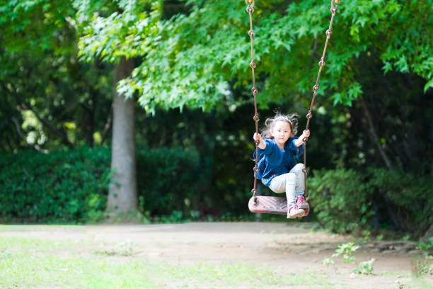 istock Little girl playing with a swing 920427286