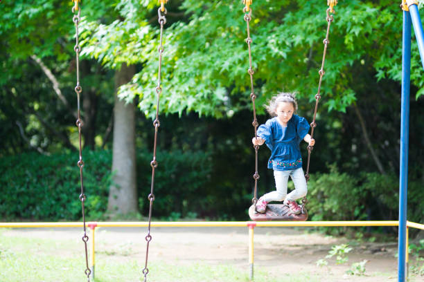 istock Little girl playing with a swing 920427326