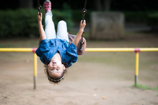 istock Little girl playing with a swing 920427328