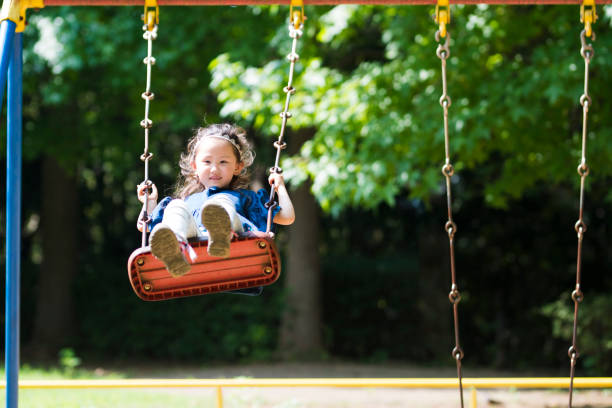 istock Little girl playing with a swing 920427512