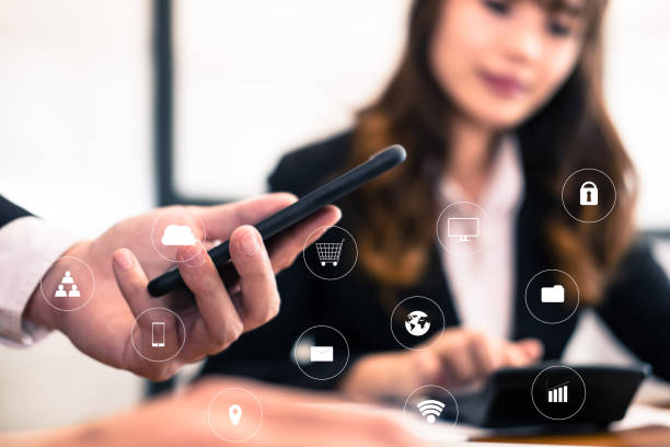istock businessman analyze financial chart in smartphone . business team working with startup project. man & woman discussing market plan report at workplace. discussion, teamwork with internet of thing icon 920428040