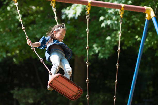 istock Little girl playing with a swing 920428054