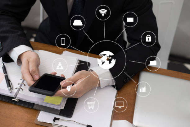 istock businessman holding smartphone & using app. man texting message at office. social network communication, wireless connection, lifestyle concept with internet of thing icon 920428920