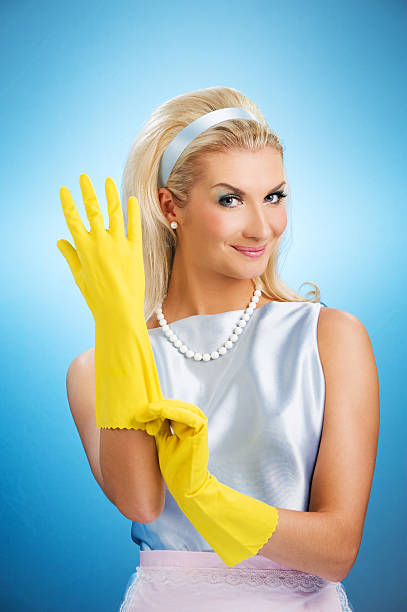 Beautiful happy housewife with rubber gloves stock photo
