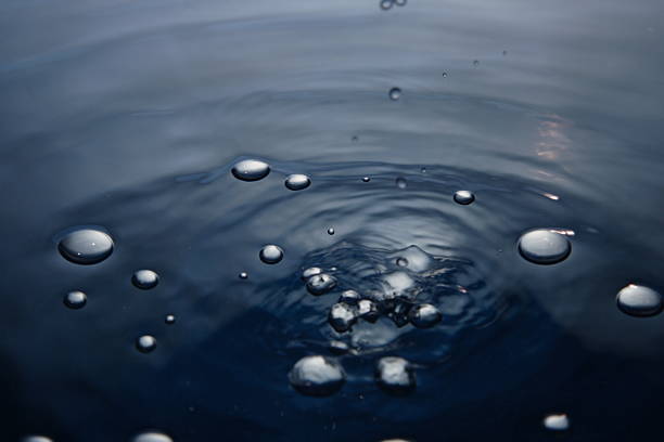 rain drop in water stock photo