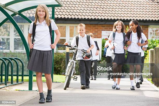 Junior Children Leaving School Stock Photo - Download Image Now - Walking, School Building, Education