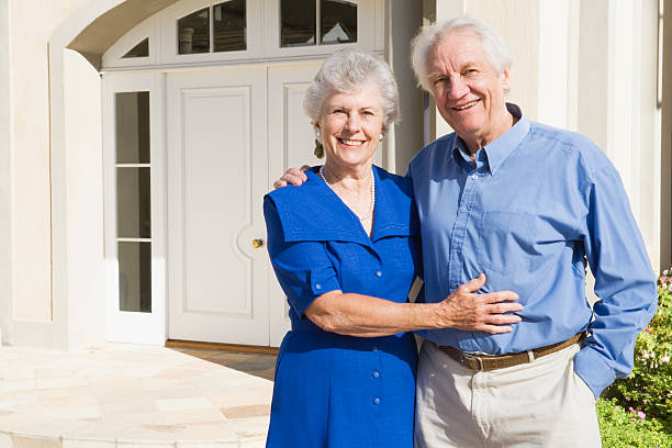 istock Senior couple outside house with blue shirts 92044493