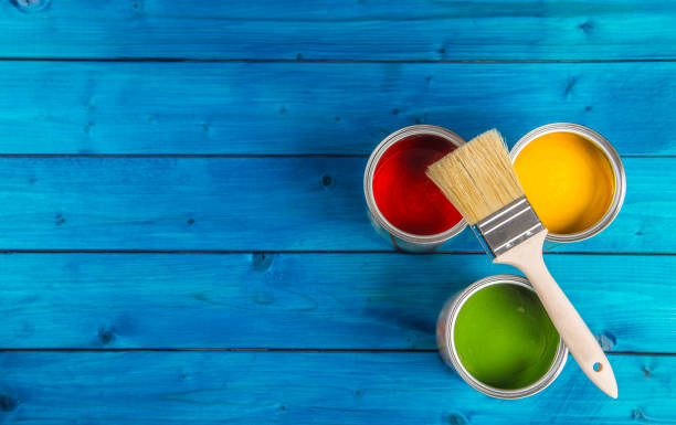 istock Paint cans color palette, cans opened with brushes on blue table 920449258