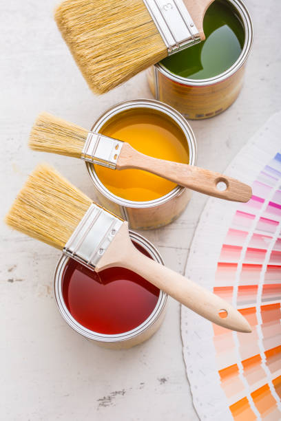 istock Paint cans color palette, cans opened with brushes on white board 920449312