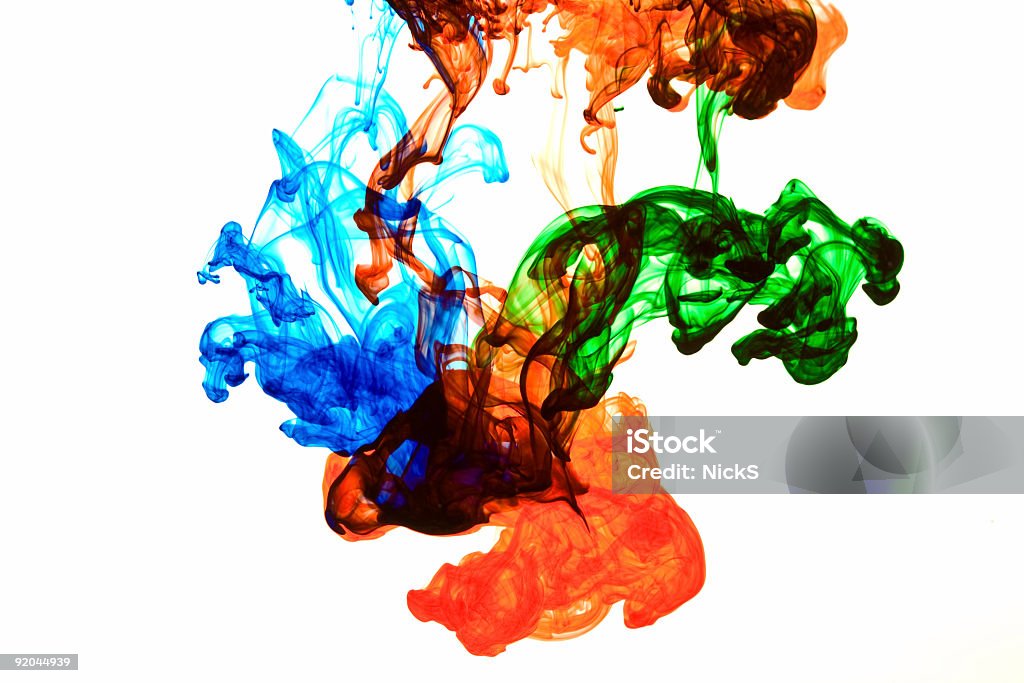 Blue, red and green ink dispersing in water Blue, red, and green ink dissolving in water. Mixing Stock Photo