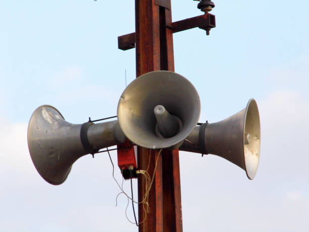 istock making announcements, making announcements with speakers, electric pole mounted speakers, 920449464