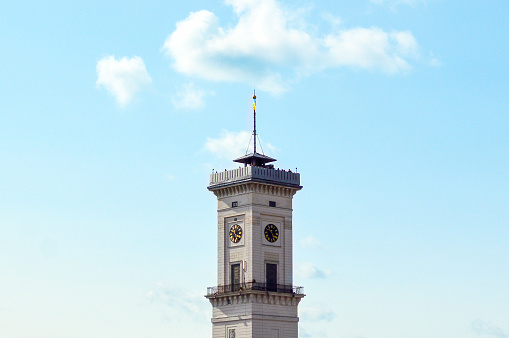 Awesome close-up view of the Lviv town hall tower from the roof of House of Legends cafe. Summer photo with the blue sky.