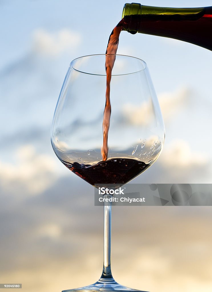 Pouring Red Wine at Sunset  Alcohol - Drink Stock Photo