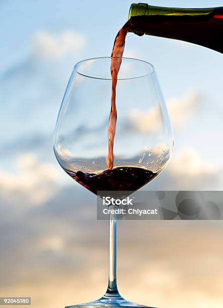Pouring Red Wine At Sunset Stock Photo - Download Image Now - Alcohol - Drink, Back Lit, Bottle