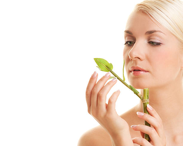 istock Beautiful young woman with a bamboo plant 92045231