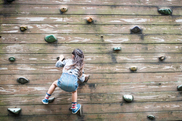 istock Little girl climbing the wall 920453872