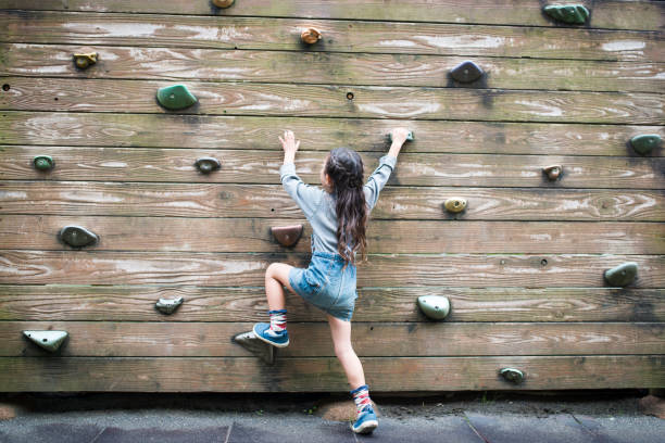istock Little girl climbing the wall 920453874
