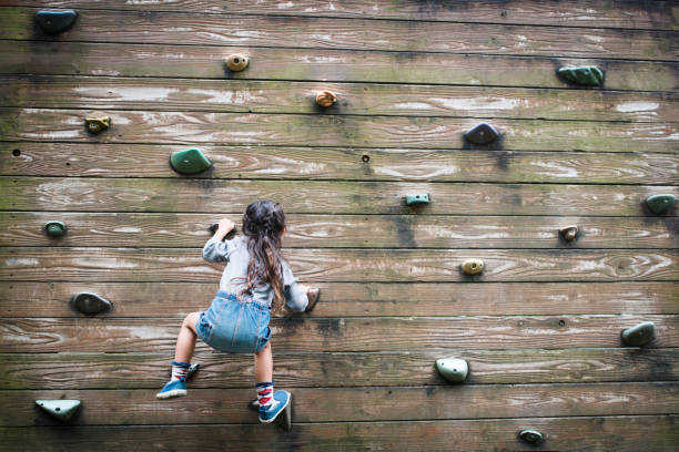 istock Little girl climbing the wall 920454104