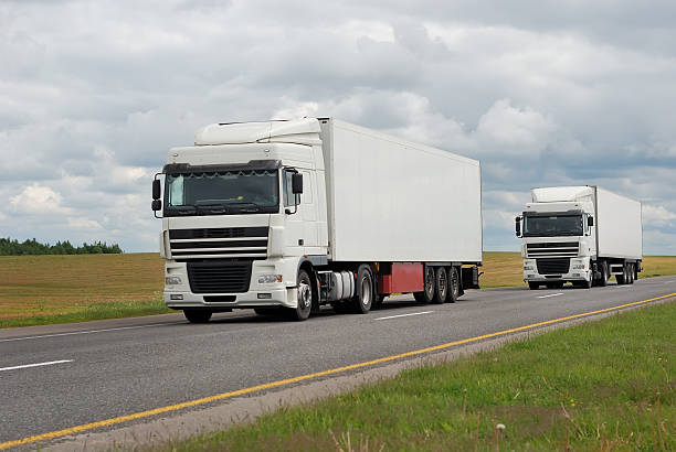 istock couple of white trucks on highway 92045758