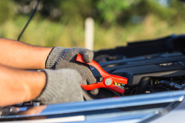 istock Hand of car technician holding cable to connect to battery 920459058