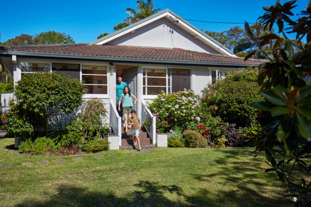 istock Boy with parents coming out of house 920459596