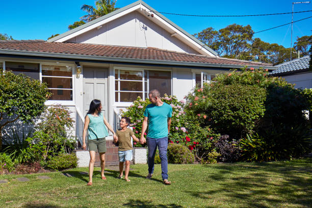 istock Boy holding hands of parents in lawn 920459598