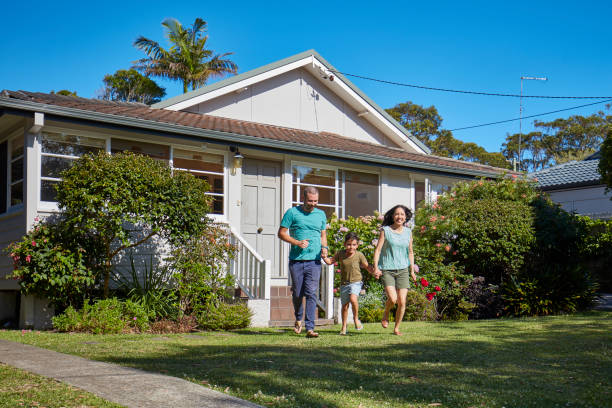 istock Boy holding hands of parents while running in lawn 920461774