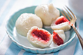 Dumplings with strawberries and cream. Sweet pierogi with berry fruit.