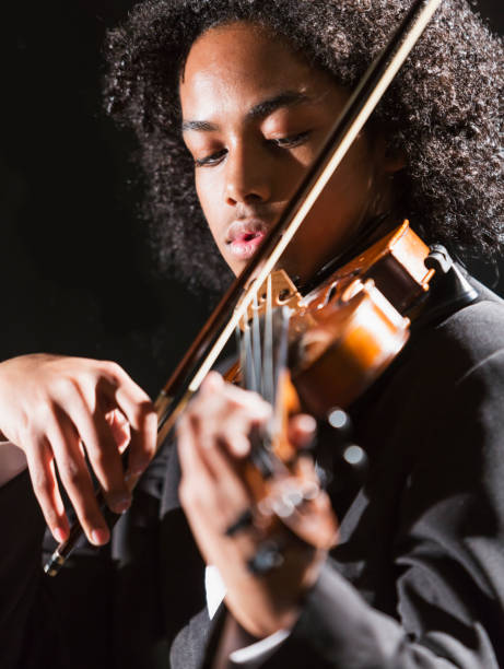 istock Mixed race teenage boy playing the violin 920479488