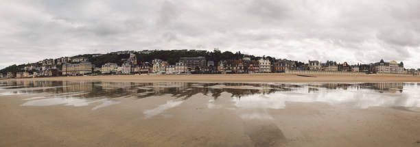 istock Reflection Of Cityscape In Sea Against Cloudy Sky 920484854