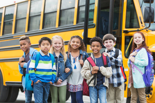 istock Elementary school children waiting outside bus 920485694