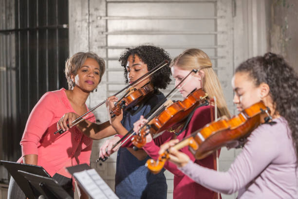 teenage violinists with music teacher - violin women violinist music imagens e fotografias de stock