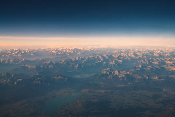 aerial view of the alps in the morning - mountain range earth sky airplane imagens e fotografias de stock