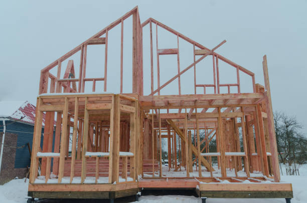 istock construction of wooden frame house in winter 920490692