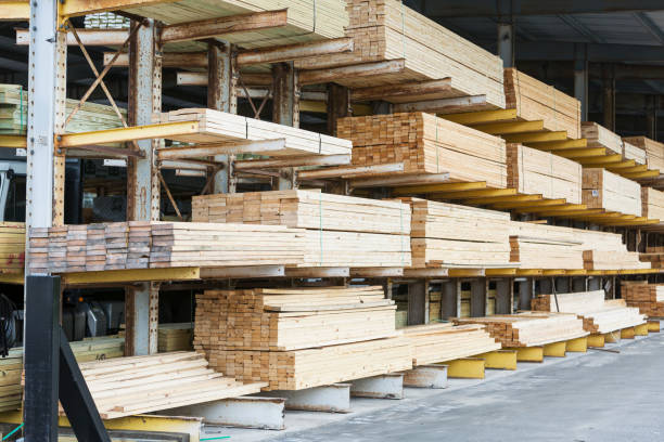 Storage shelves in lumberyard Warehouse at a lumberyard with stacks of construction material on shelves. timber stock pictures, royalty-free photos & images