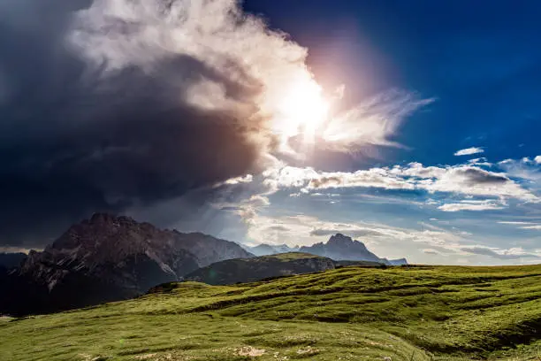 A storm cloud is coming in the sun. The beginning of the storm. National Nature Park Tre Cime In the Dolomites Alps. Beautiful nature of Italy.