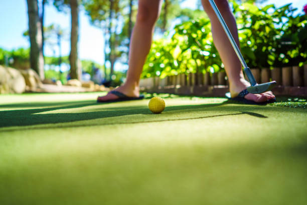 istock Mini Golf yellow ball with a bat at sunset 920496456