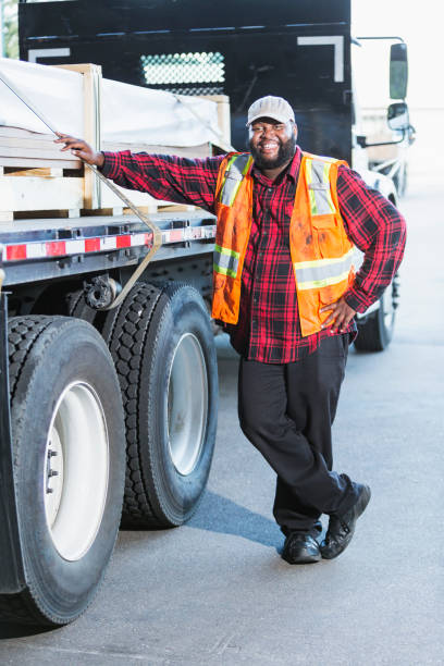 istock Worker standing by truck loaded with building material 920497218