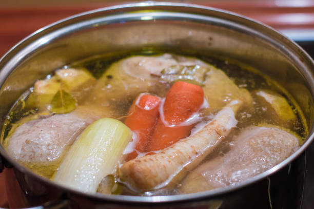 istock Chicken broth with vegetables being cooked in the pot. 920498056
