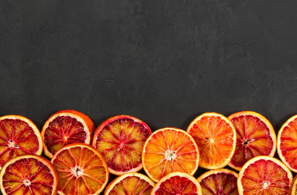 istock Red bloody oranges on black background. 920503510