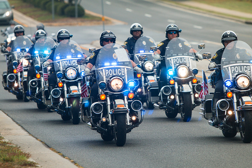 Buford, GA - October 7, 2017: Several police officers on motorcycles provide an escort to a group of motorcyclists about to start the third annual Ride To Survive charity bike ride on October 7, 2017 in Buford, GA.