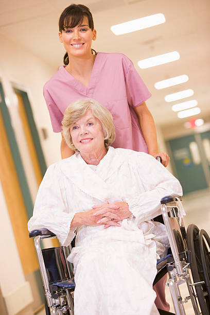 istock Nurse Pushing Woman In A Wheelchair 92050936