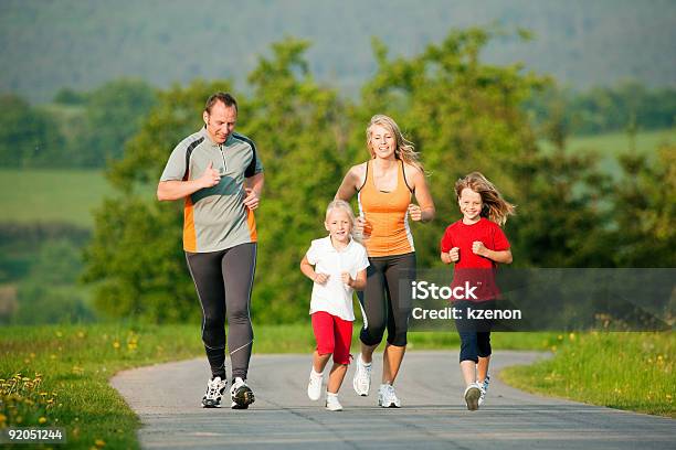 Family Jogging Outdoors Stock Photo - Download Image Now - Exercising, Family, Healthy Lifestyle