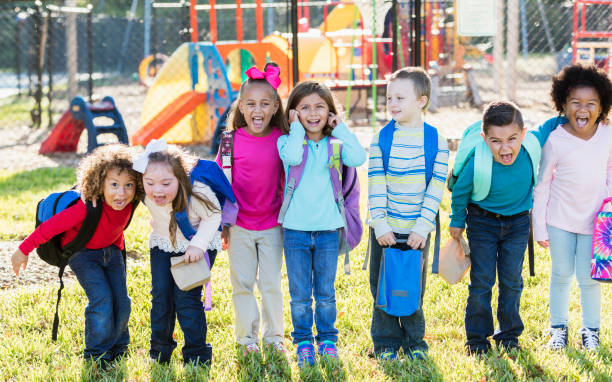 istock Multi-ethnic group of school children standing in a row 920513402