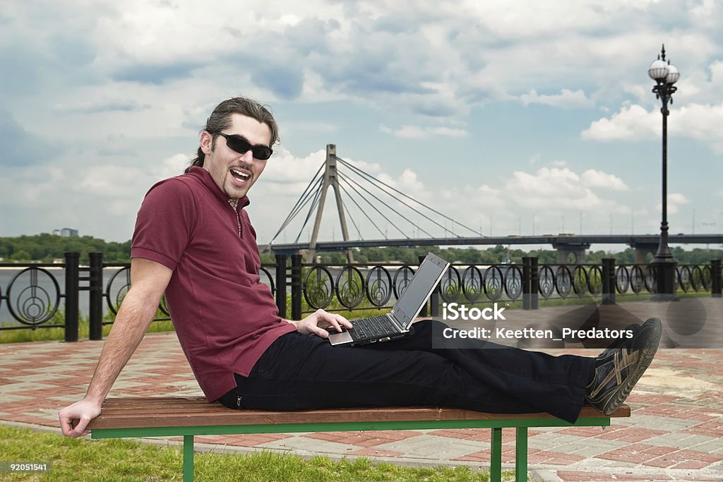 Guy with laptop in the park  20-29 Years Stock Photo